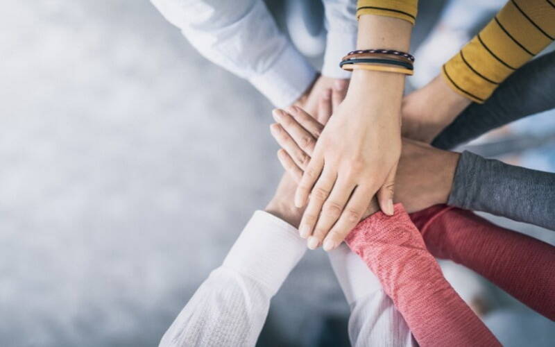 Diverse hands stacked on top on each other