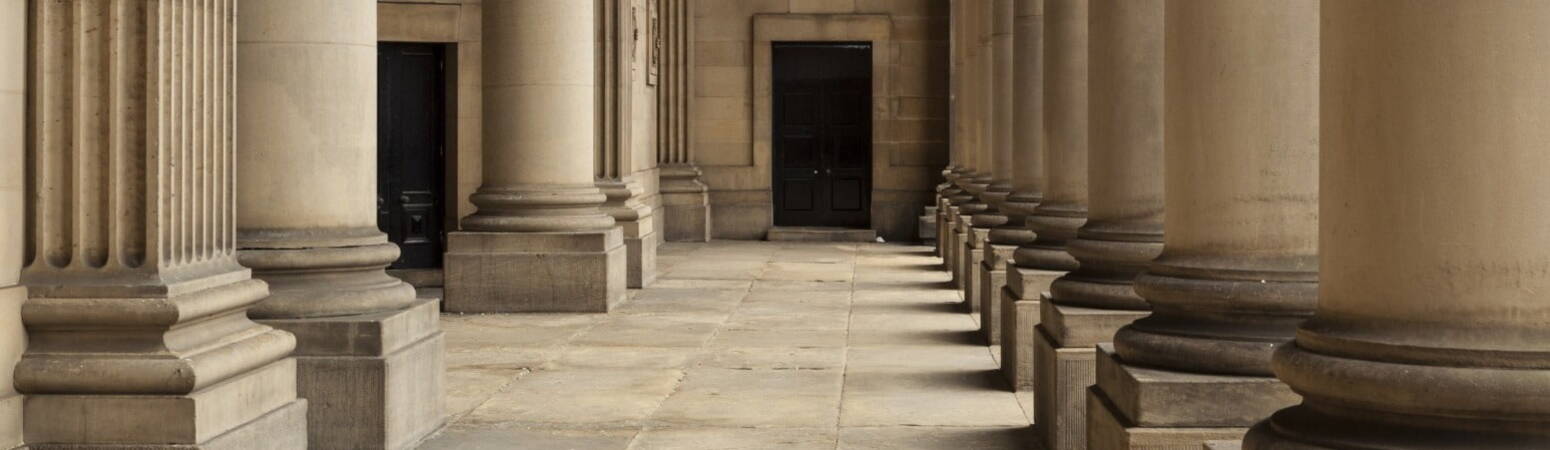 A row of pillars before the entrance to legal building