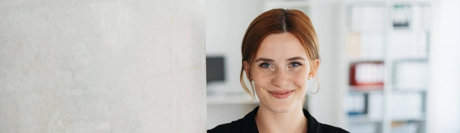 Red head woman smiling at the camera