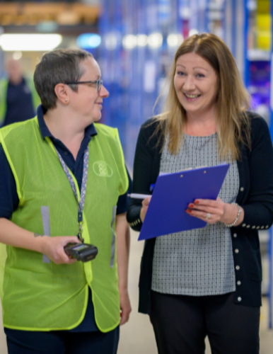 Four diverse people standing in a line having attended a workshop